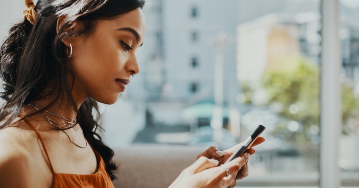 Young woman surfing the internet on mobile phone