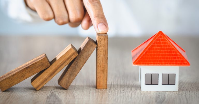 hand-stopping-risk-the-wooden-blocks-from-falling-on-house